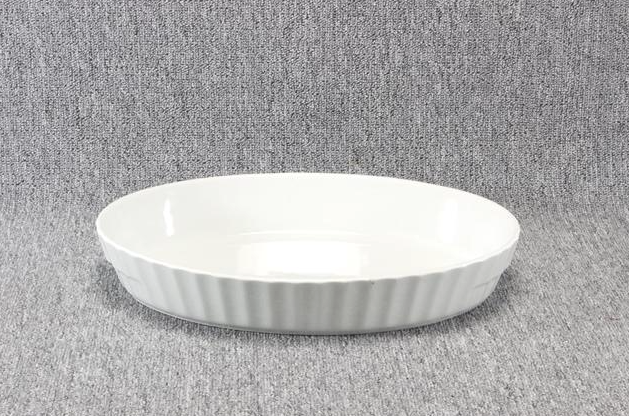 Eight shirts arranged on table in black, olive, grey, blue, white, red, mustard, and green.