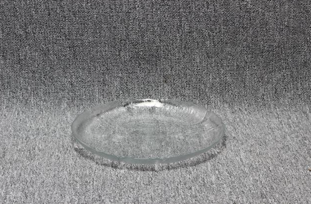 Eight shirts arranged on table in black, olive, grey, blue, white, red, mustard, and green.