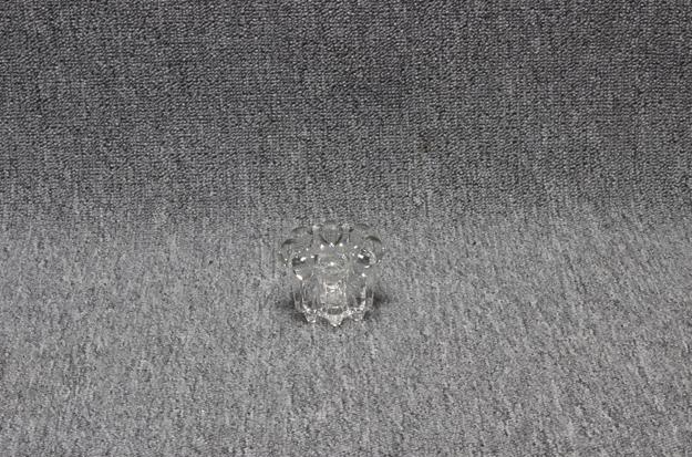 Eight shirts arranged on table in black, olive, grey, blue, white, red, mustard, and green.