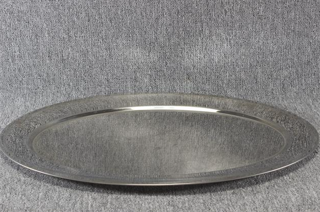 Eight shirts arranged on table in black, olive, grey, blue, white, red, mustard, and green.