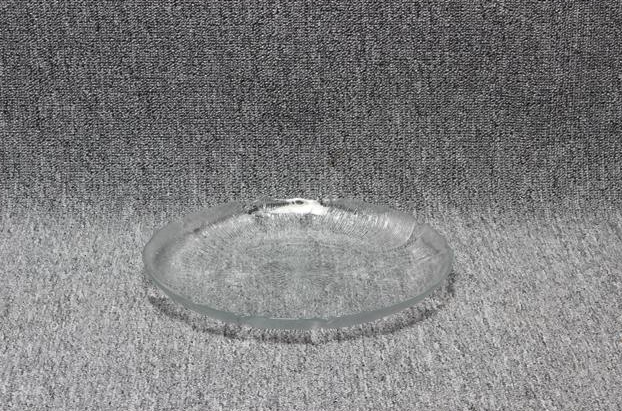 Eight shirts arranged on table in black, olive, grey, blue, white, red, mustard, and green.