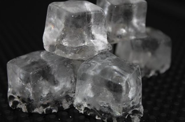 Eight shirts arranged on table in black, olive, grey, blue, white, red, mustard, and green.