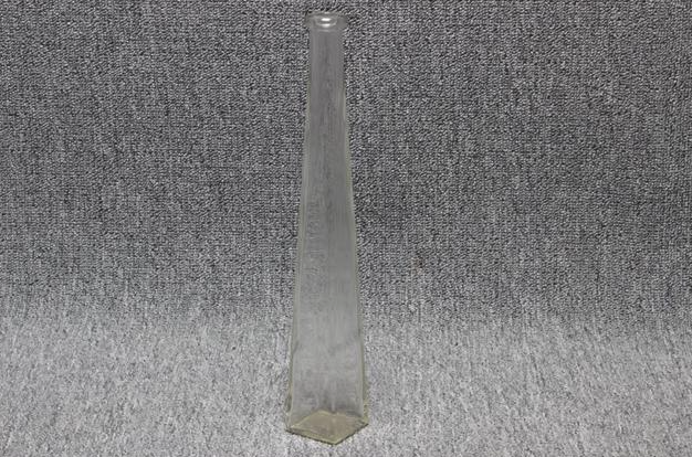 Eight shirts arranged on table in black, olive, grey, blue, white, red, mustard, and green.