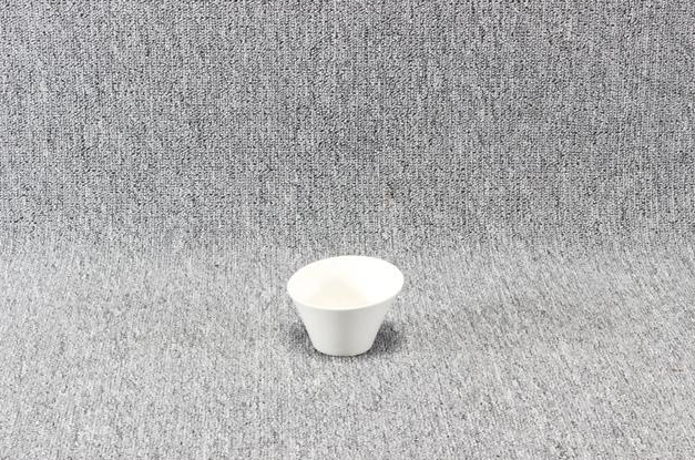 Eight shirts arranged on table in black, olive, grey, blue, white, red, mustard, and green.