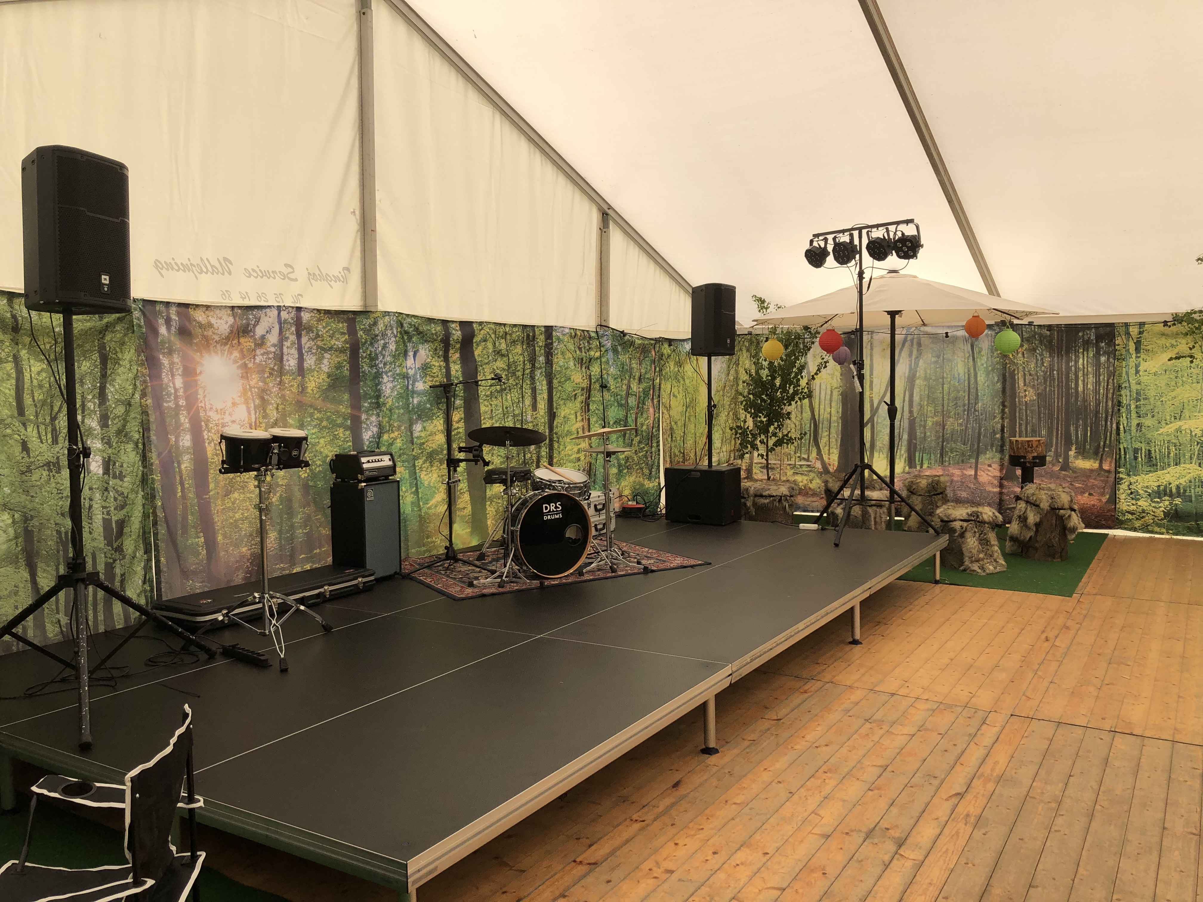 Eight shirts arranged on table in black, olive, grey, blue, white, red, mustard, and green.
