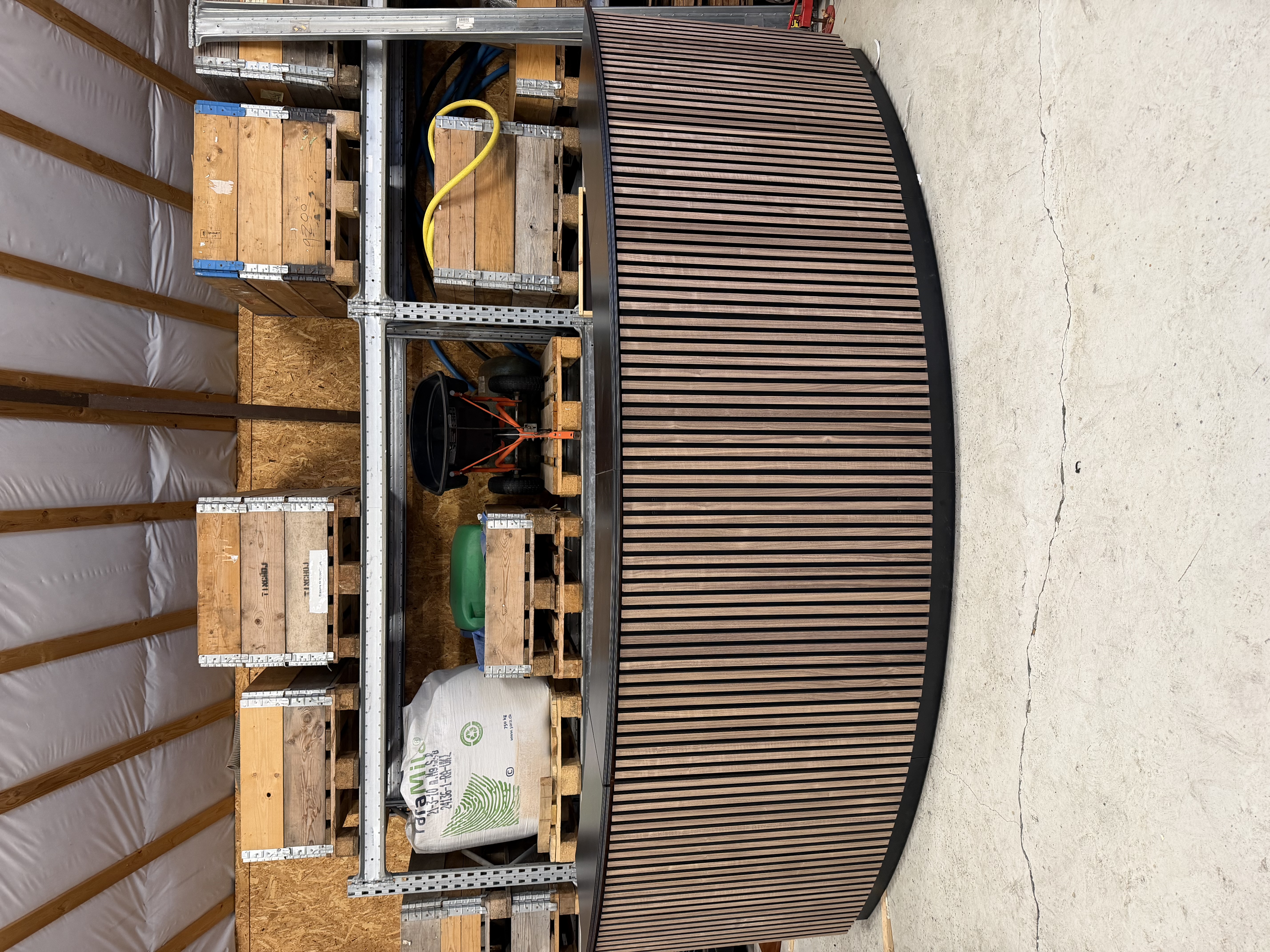 Eight shirts arranged on table in black, olive, grey, blue, white, red, mustard, and green.