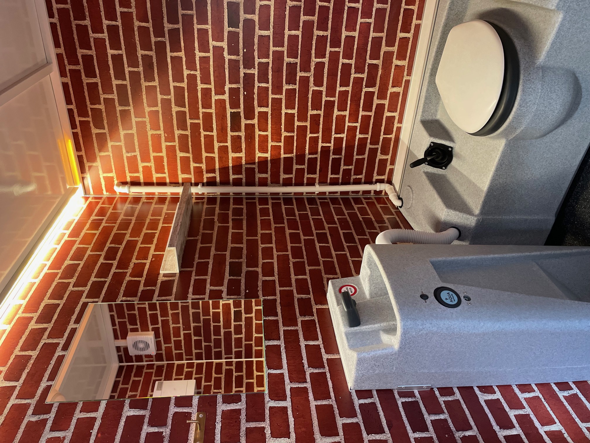 Eight shirts arranged on table in black, olive, grey, blue, white, red, mustard, and green.