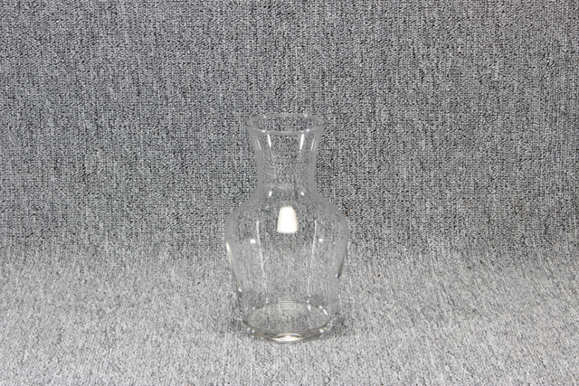 Eight shirts arranged on table in black, olive, grey, blue, white, red, mustard, and green.