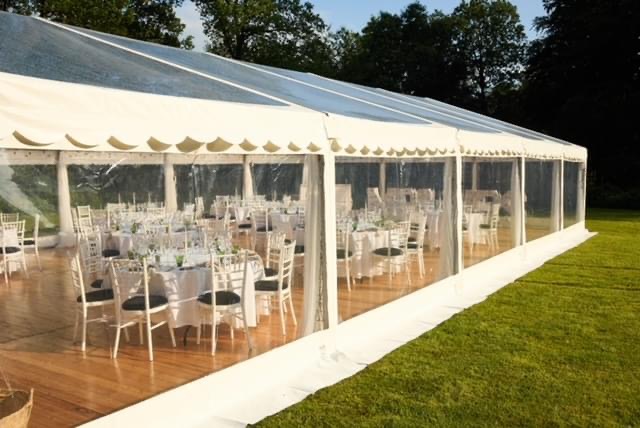 Eight shirts arranged on table in black, olive, grey, blue, white, red, mustard, and green.