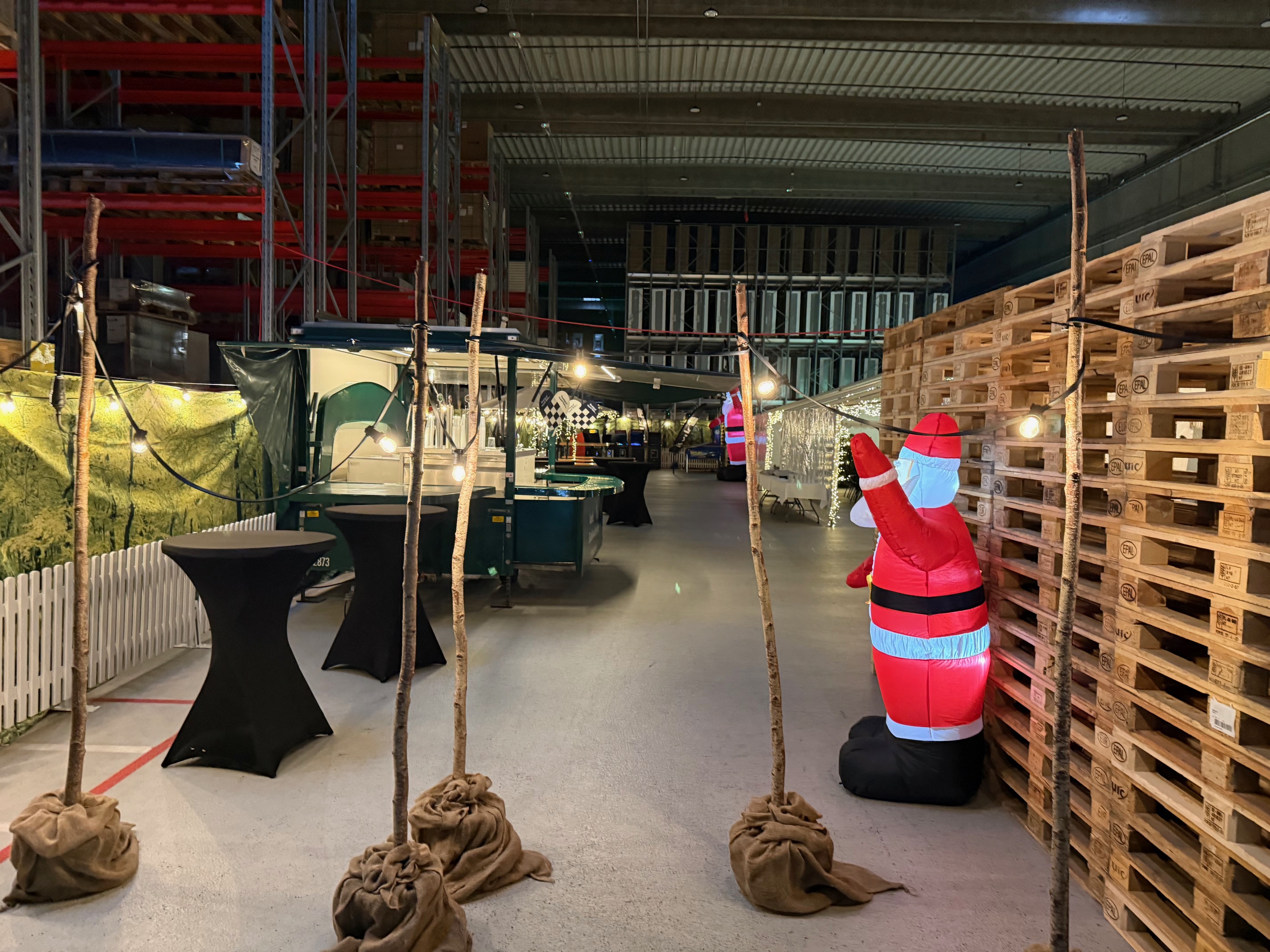 Eight shirts arranged on table in black, olive, grey, blue, white, red, mustard, and green.