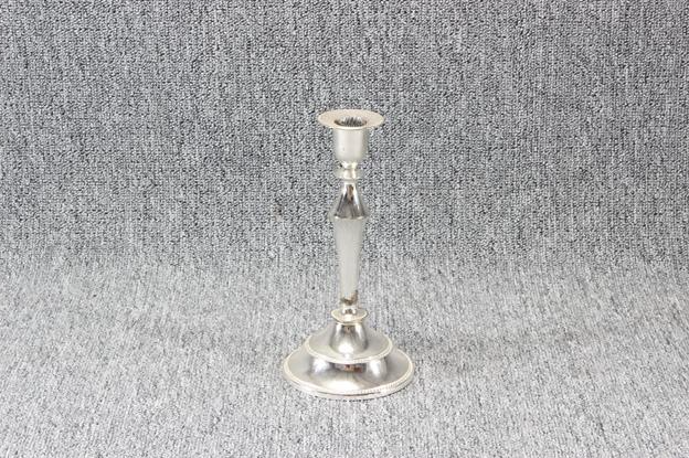 Eight shirts arranged on table in black, olive, grey, blue, white, red, mustard, and green.