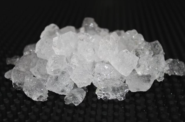 Eight shirts arranged on table in black, olive, grey, blue, white, red, mustard, and green.