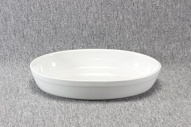 Eight shirts arranged on table in black, olive, grey, blue, white, red, mustard, and green.