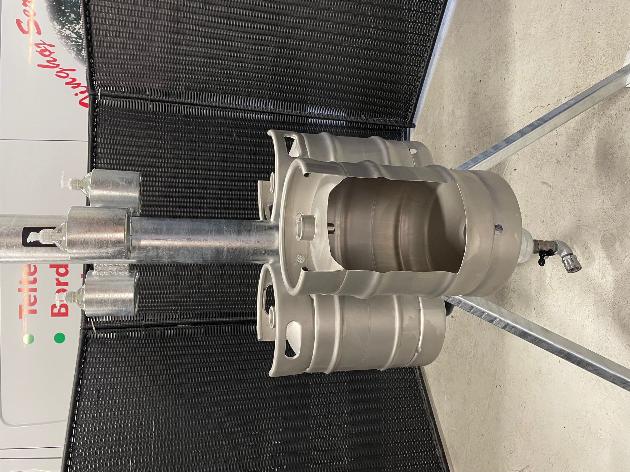 Eight shirts arranged on table in black, olive, grey, blue, white, red, mustard, and green.