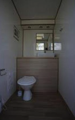 Eight shirts arranged on table in black, olive, grey, blue, white, red, mustard, and green.