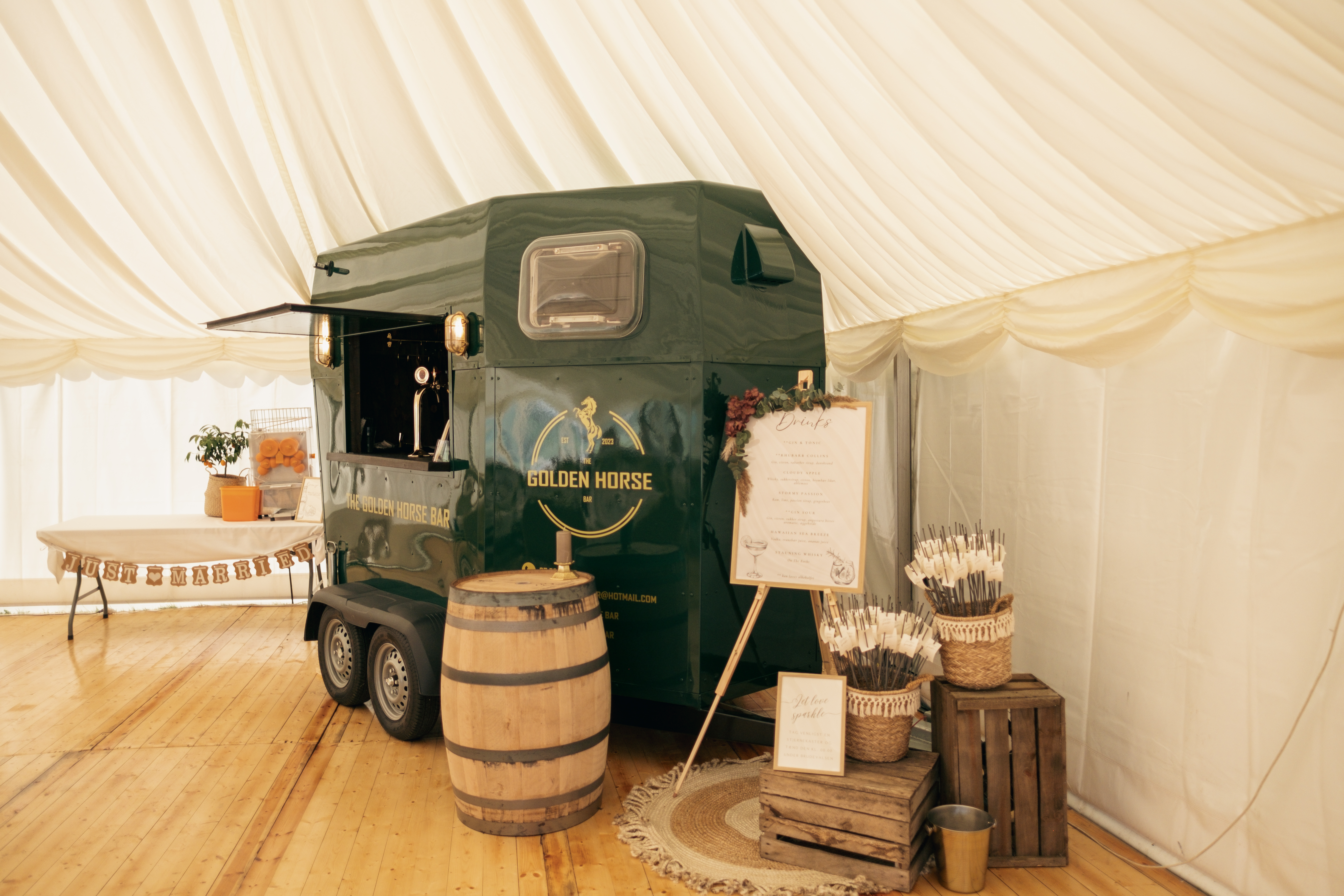 Eight shirts arranged on table in black, olive, grey, blue, white, red, mustard, and green.