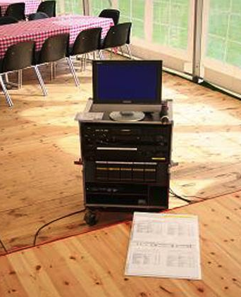 Eight shirts arranged on table in black, olive, grey, blue, white, red, mustard, and green.