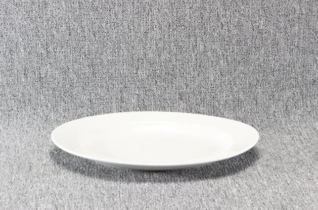 Eight shirts arranged on table in black, olive, grey, blue, white, red, mustard, and green.